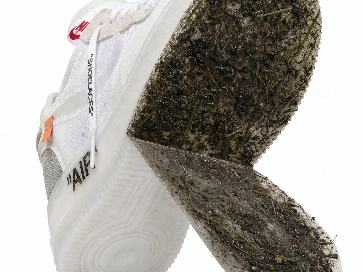 The SneakerSoul protector peeling off an Off-White Air Force 1 — every bit of mud and grass stuck to the sheet, the outsole underneath still factory icy