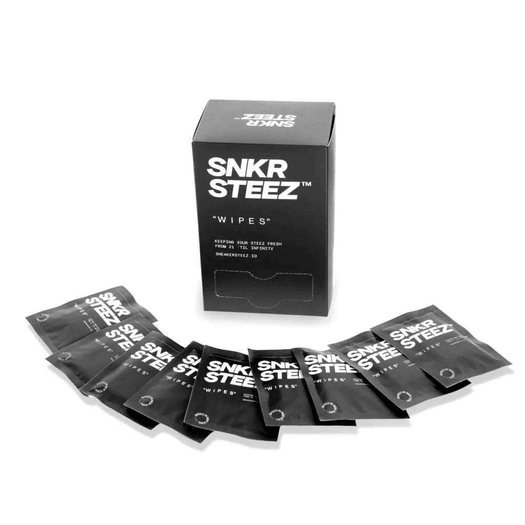 Box of SNKR STEEZ wipes with individual wipe packets fanned out in front.
